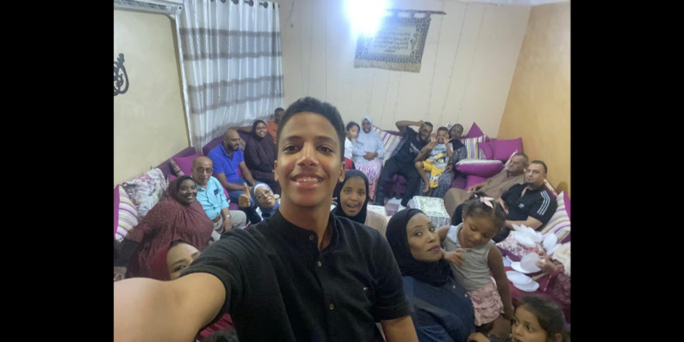 Young man taking a selfie with his family