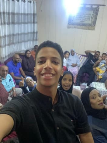 Young man taking a selfie with his family