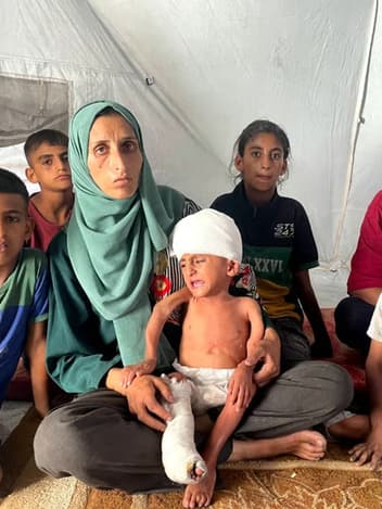 Family sitting together in a tent