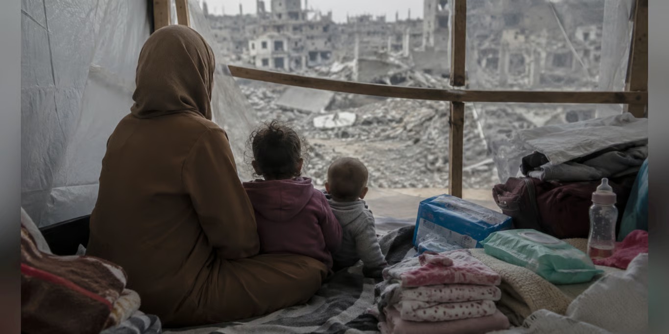 Mother and children looking out over a destroyed city