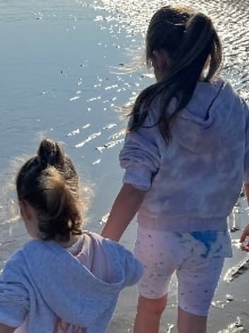 Two sisters walking along the beach