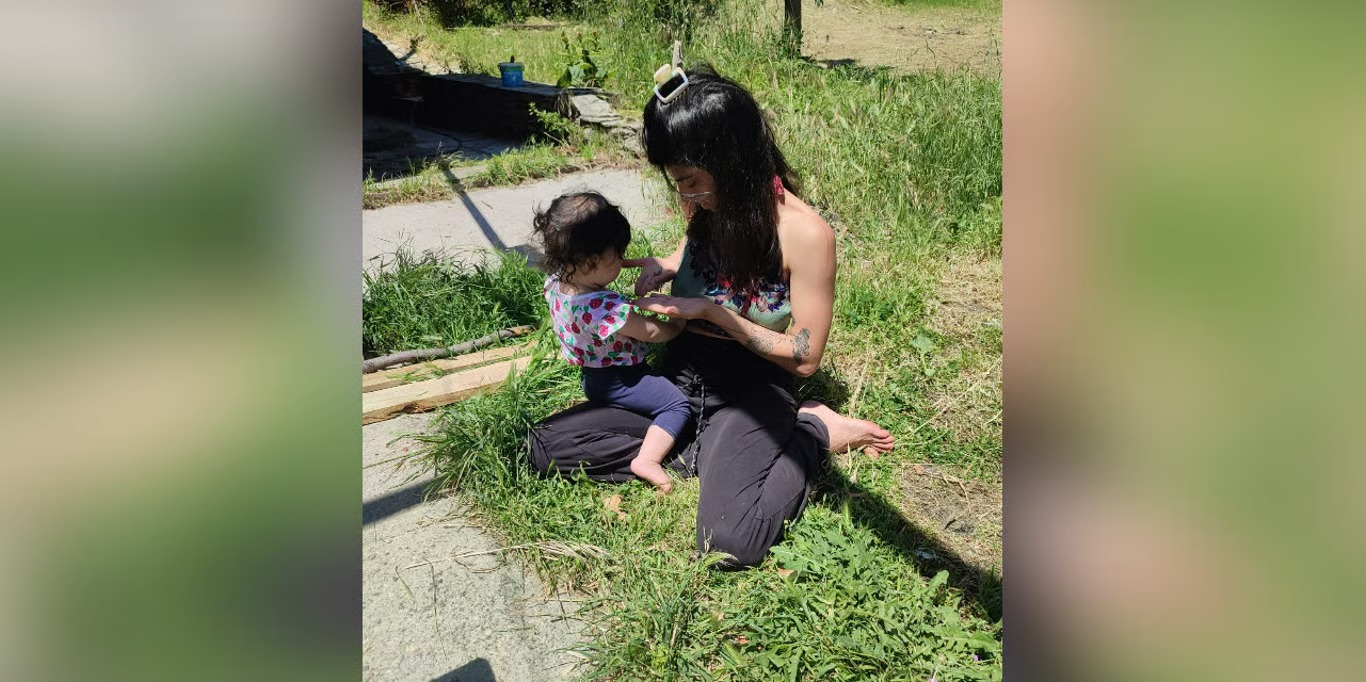 Mother playing with her baby in the garden