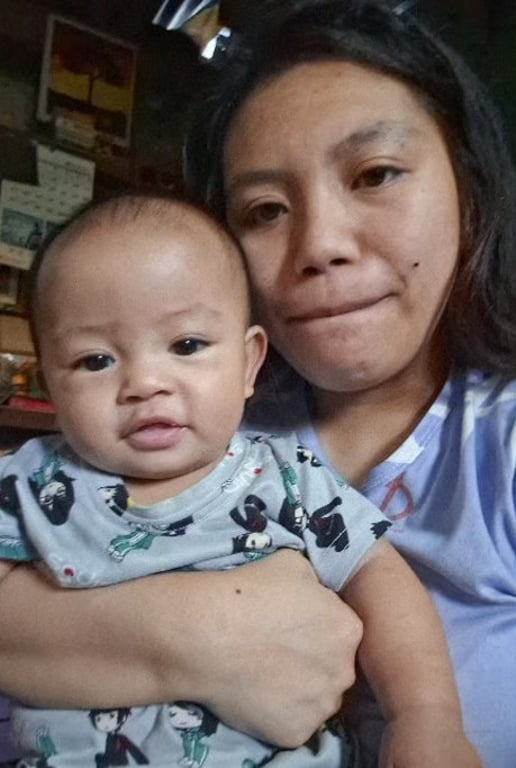 Mother holding her baby son