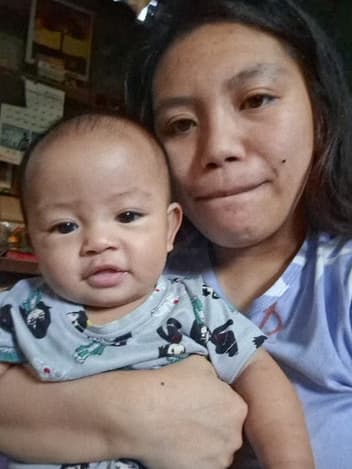 Mother holding her baby son