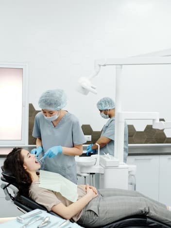 Dentist treating a patient in the chair