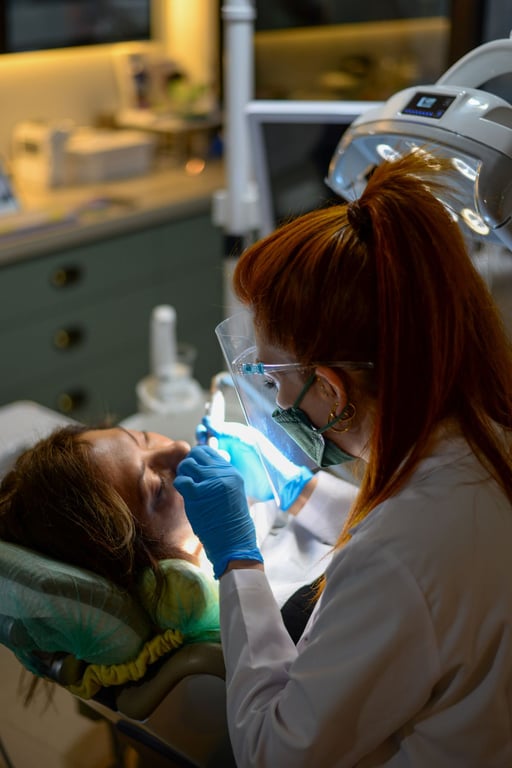 Dentist examining a patient under the lamp