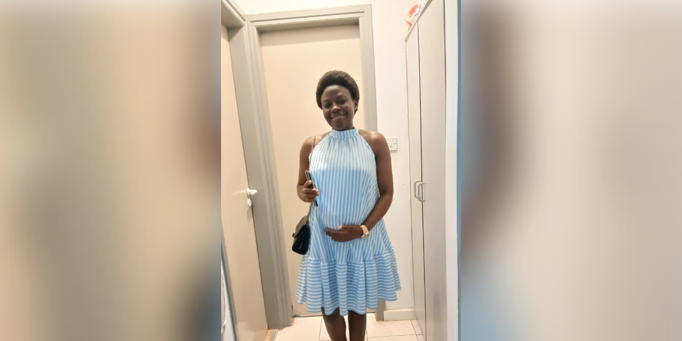 Smiling expectant mother in a striped dress