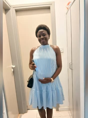 Smiling expectant mother in a striped dress