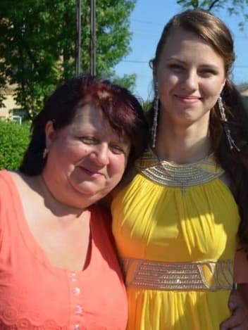 Mother and daughter smiling outdoors