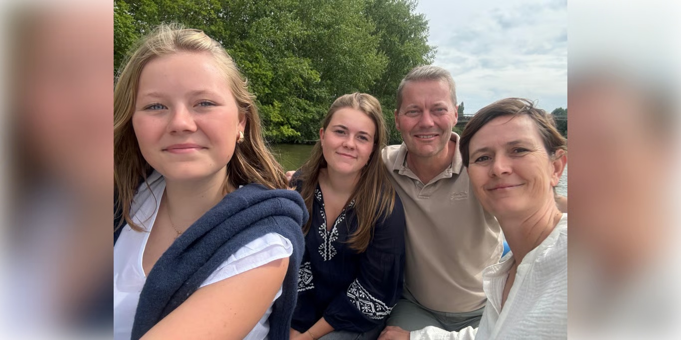 Family smiling together by the river