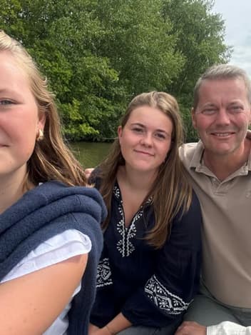 Family smiling together by the river