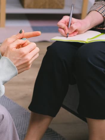 Therapist taking notes during a session