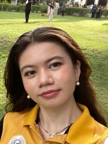 Young woman smiling on a university lawn