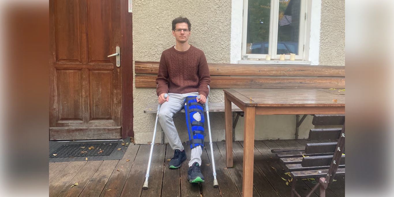 Young man with a leg brace and crutches