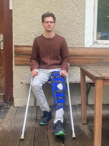 Young man with a leg brace and crutches