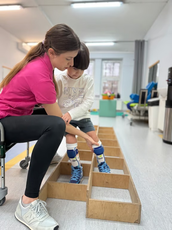 Physiotherapist guiding a child through exercises
