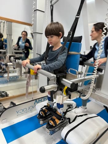 Child in a gait-training machine