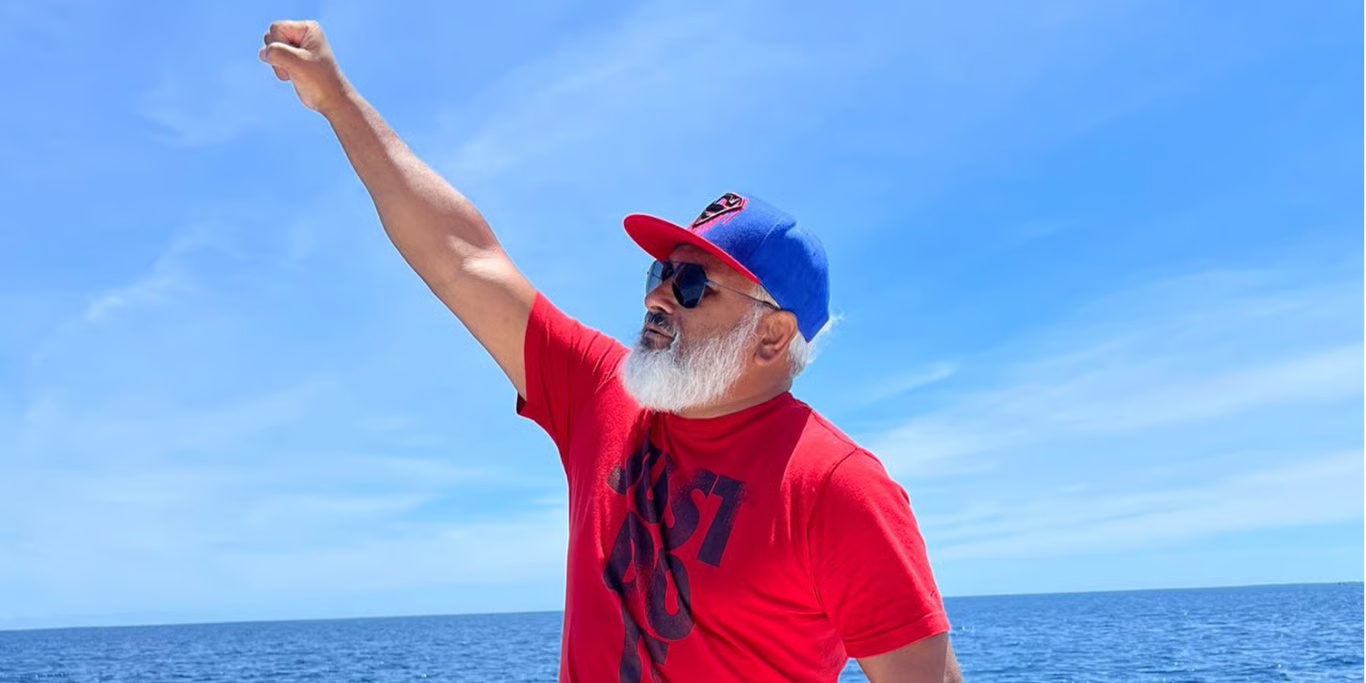Man raising his fist by the sea