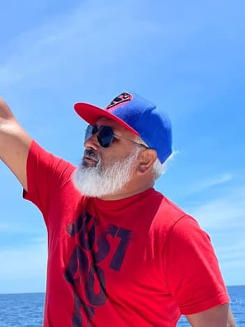 Man raising his fist by the sea