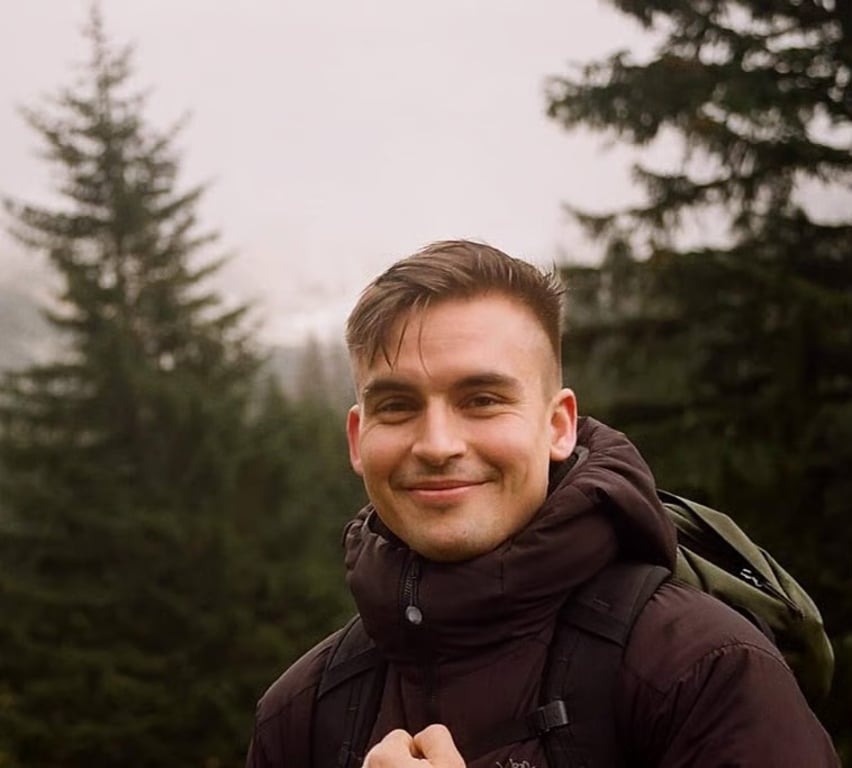 Smiling man on a misty forest hike
