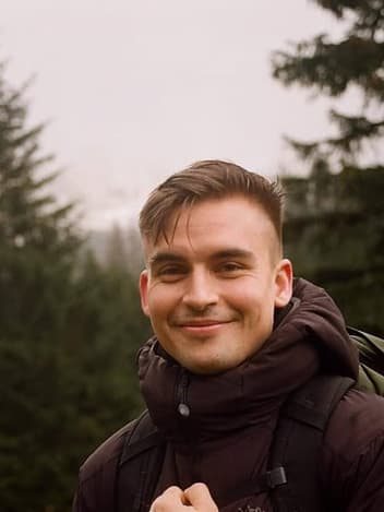 Smiling man on a misty forest hike