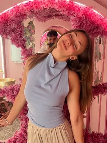 Young woman smiling in a flower arch