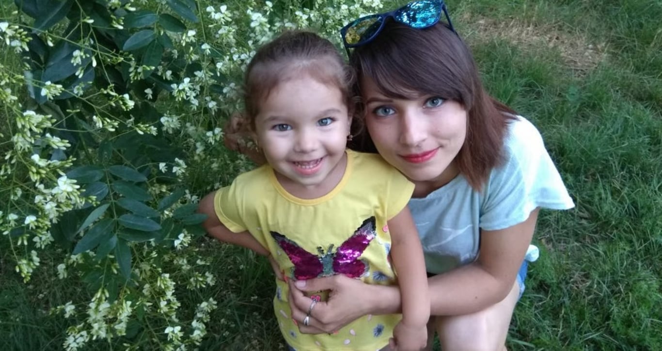 Mother and daughter smiling in the garden