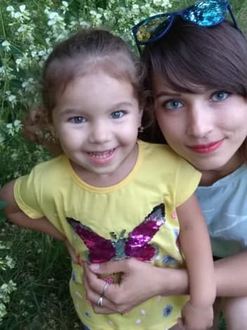 Mother and daughter smiling in the garden