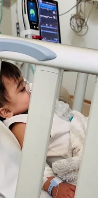 Baby resting in a hospital cot