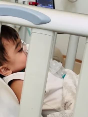 Baby resting in a hospital cot