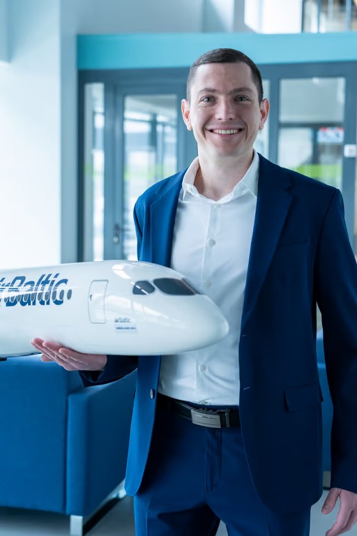 Smiling man holding a model plane