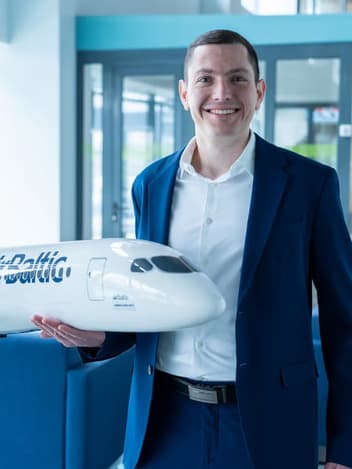 Smiling man holding a model plane