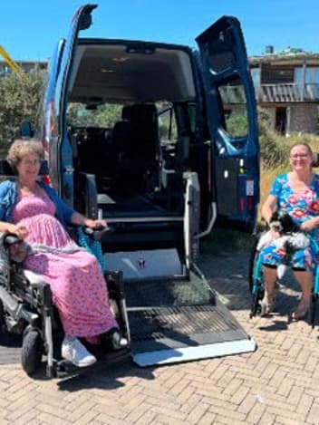 Wheelchair users boarding an accessible van