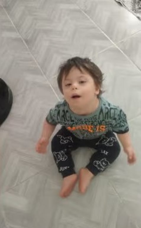 Toddler sitting on the floor at home