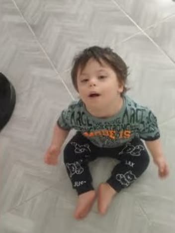 Toddler sitting on the floor at home