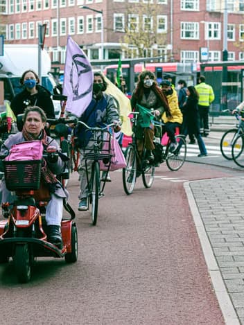 Cyclists and climate protesters riding through Amsterdam