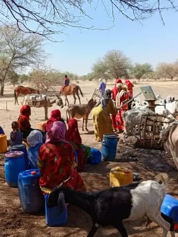 Families collecting water at a village well