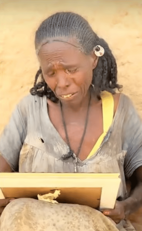 Woman in tears holding a framed photo