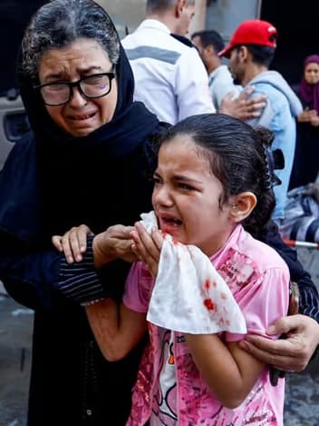 Woman comforting a crying girl after an attack