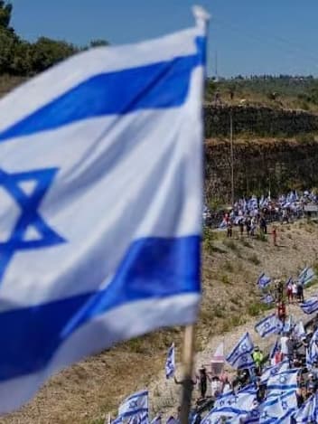 March with Israeli flags along a highway