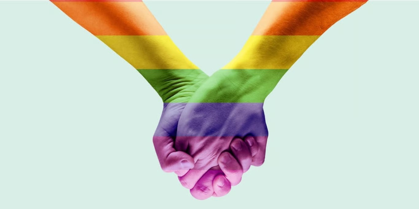 Hands painted in rainbow colours