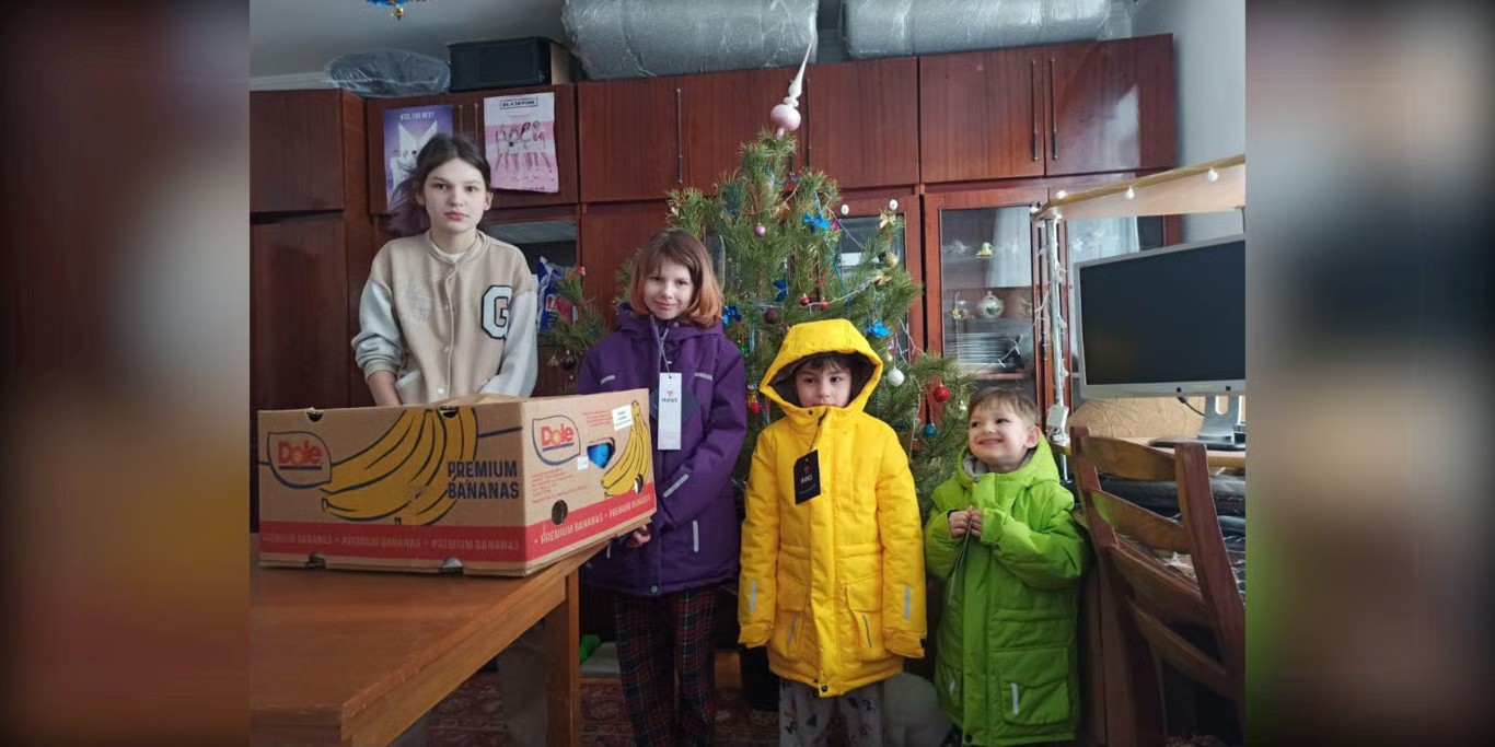 Children at a children’s home with donated coats