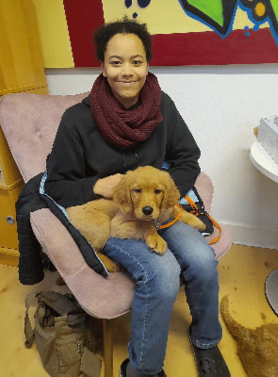 Girl with her golden retriever puppy