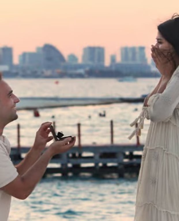 Proposal by the water at sunset