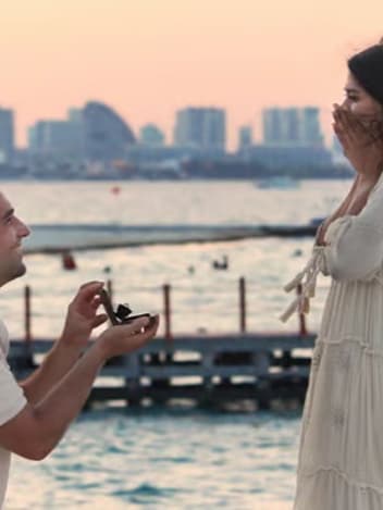 Proposal by the water at sunset