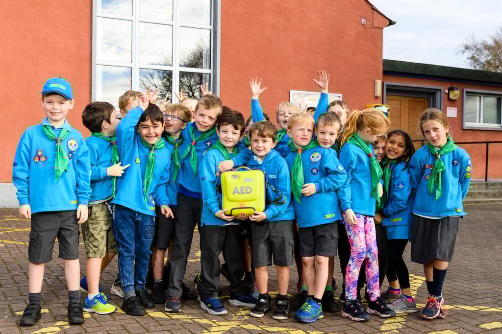 property PR photography, The Gullane Beavers have raised money for defibrillators in Gullane with the help of a £1k donation from CALA Homes (East).Jude Leslie and Kids from the Beavers group at Gullane Village Hall – where one of the defibs will be based.