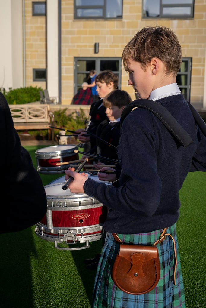 social care PR photography, Cramond Residence School pipe band performance keeps elderly residents in tune