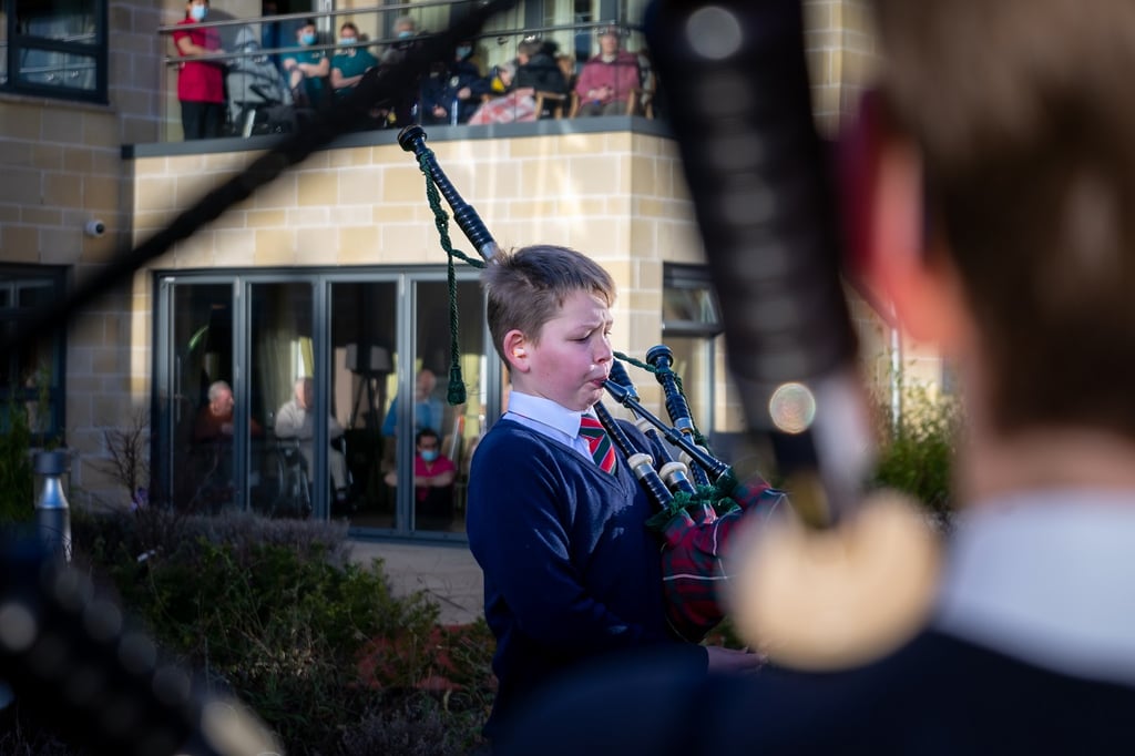 social care PR photography, Cramond Residence School pipe band performance keeps elderly residents in tune