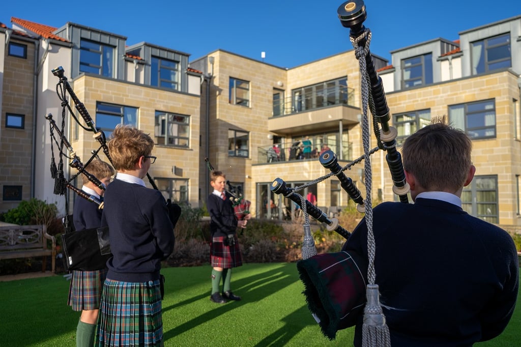 social care PR photography, Cramond Residence School pipe band performance keeps elderly residents in tune