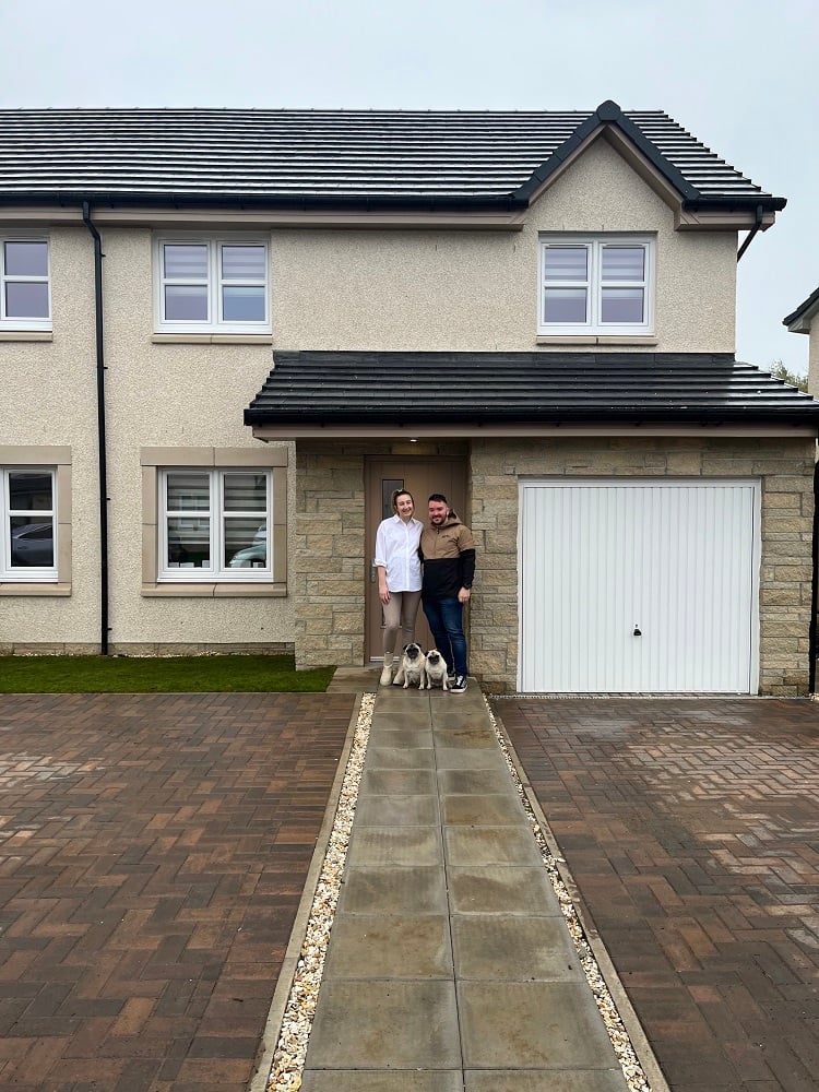 Calum and Alice, happy buyers at Gilbertfield Woods shown in PR Scotland photography